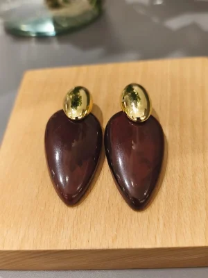 BRINCO MET OVAL DOURADO